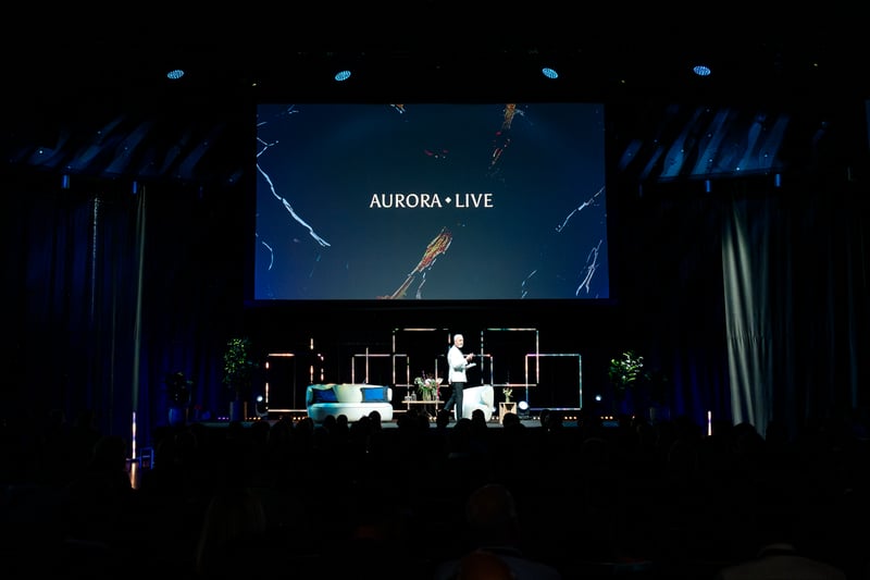 Man on stage giving keynote speech in front of