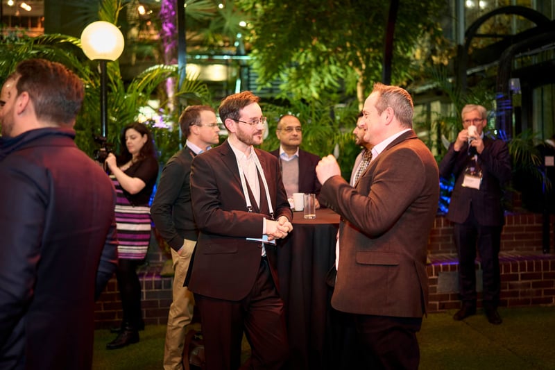 Two business men having a conversation at an executive event